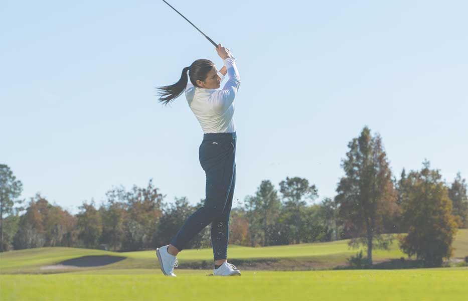 woman golfer swinging a club